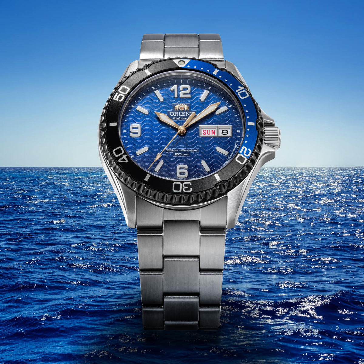 Men's stainless steel automatic watch with blue dial, bezel markers, and bracelet clasp