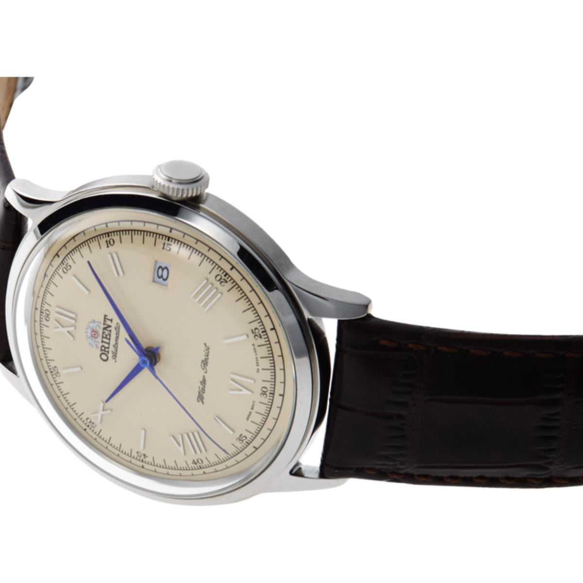 Round men's watch with cream dial, blue hands, brown leather strap, visible side crown