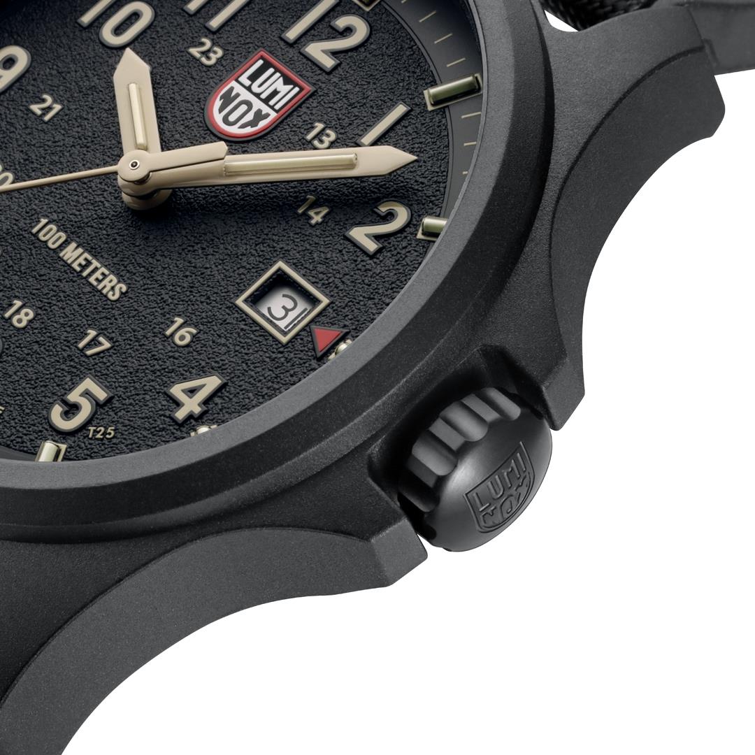 Side view of black field watch with crown, textured case, and luminous hour markers