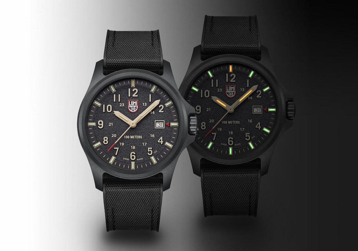 Pair of black quartz field watches with textured straps and dials with luminous markings