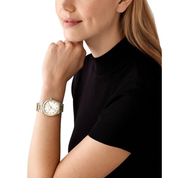 Two-tone steel quartz watch with white dial worn on model's wrist, gold-tone accents