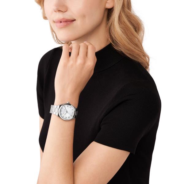 Women's stainless steel wristwatch on wrist with white dial and Roman numerals