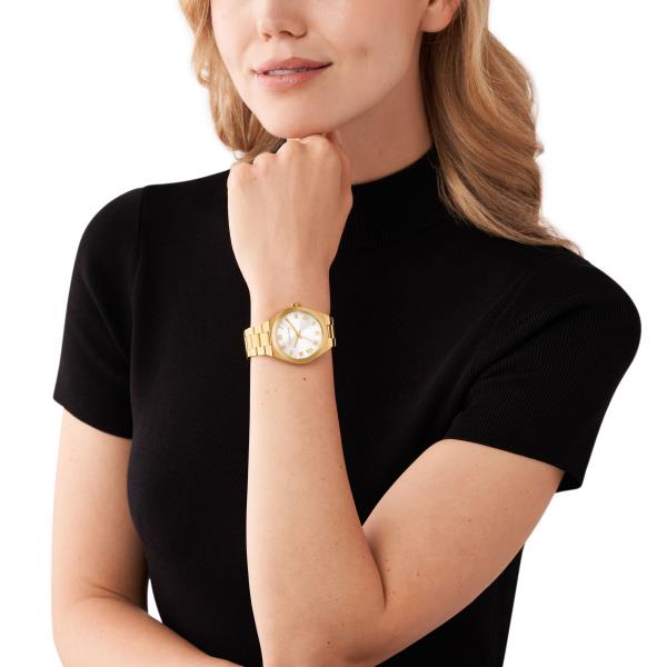 Gold-tone bracelet watch on wrist, white dial with Roman numeral markers