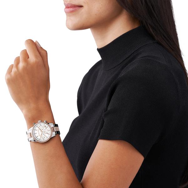 Two-tone crystal watch worn on wrist, silver dial with rose-gold bezel