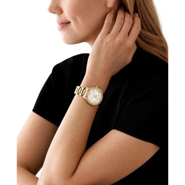 Gold-tone women’s wristwatch on wrist with white dial and crystal bezel