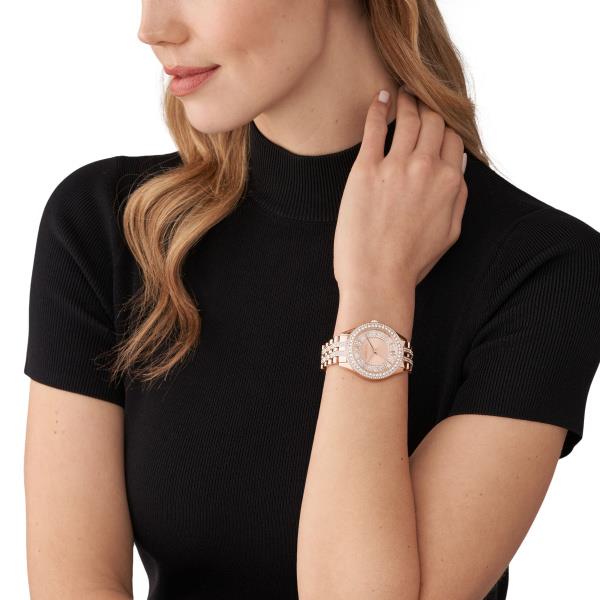 Rose gold-tone watch on wrist with crystal bezel and bracelet links