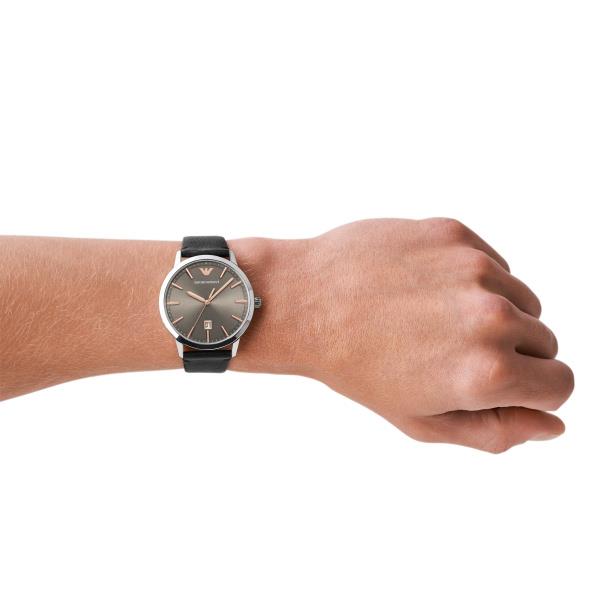 Mens quartz watch on wrist with grey dial and black leather strap