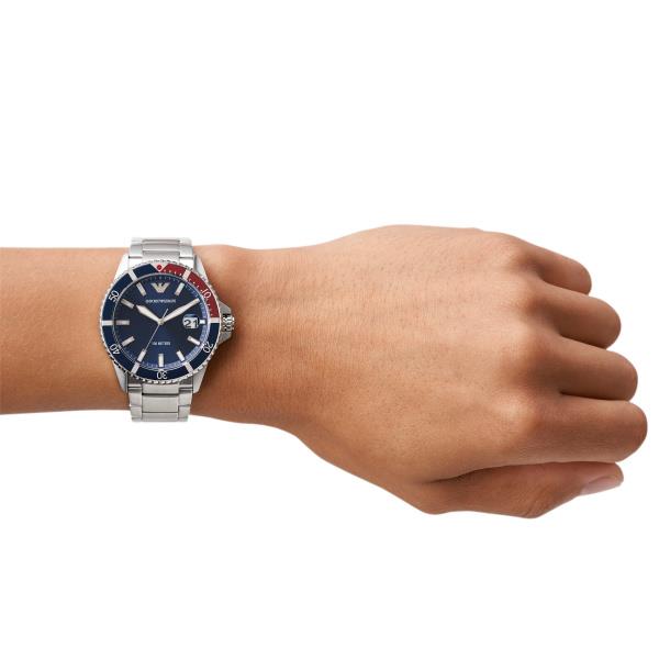 Men's diver quartz watch on wrist with blue dial and steel bracelet
