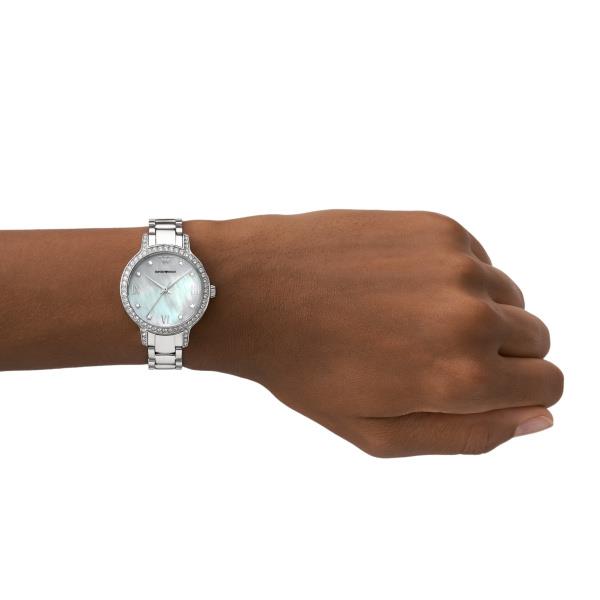 Ladies quartz watch on wrist, mother-of-pearl dial with Roman numerals, steel bracelet