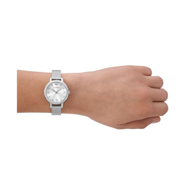 Ladies quartz wristwatch on wrist with silver dial and steel mesh bracelet