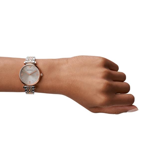 Ladies quartz watch worn on wrist, gray dial and two-tone steel bracelet