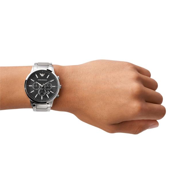 Mens wrist watch with black dial and stainless steel bracelet worn on forearm