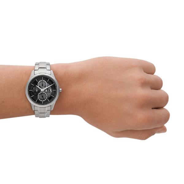 Stainless steel chronograph watch on wrist with black dial and metal bracelet