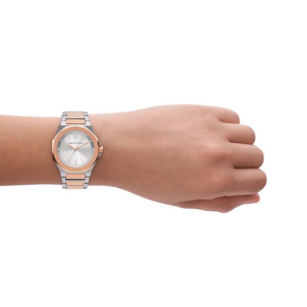 Ladies silver steel quartz watch with rose-gold bezel, on-wrist view, white dial