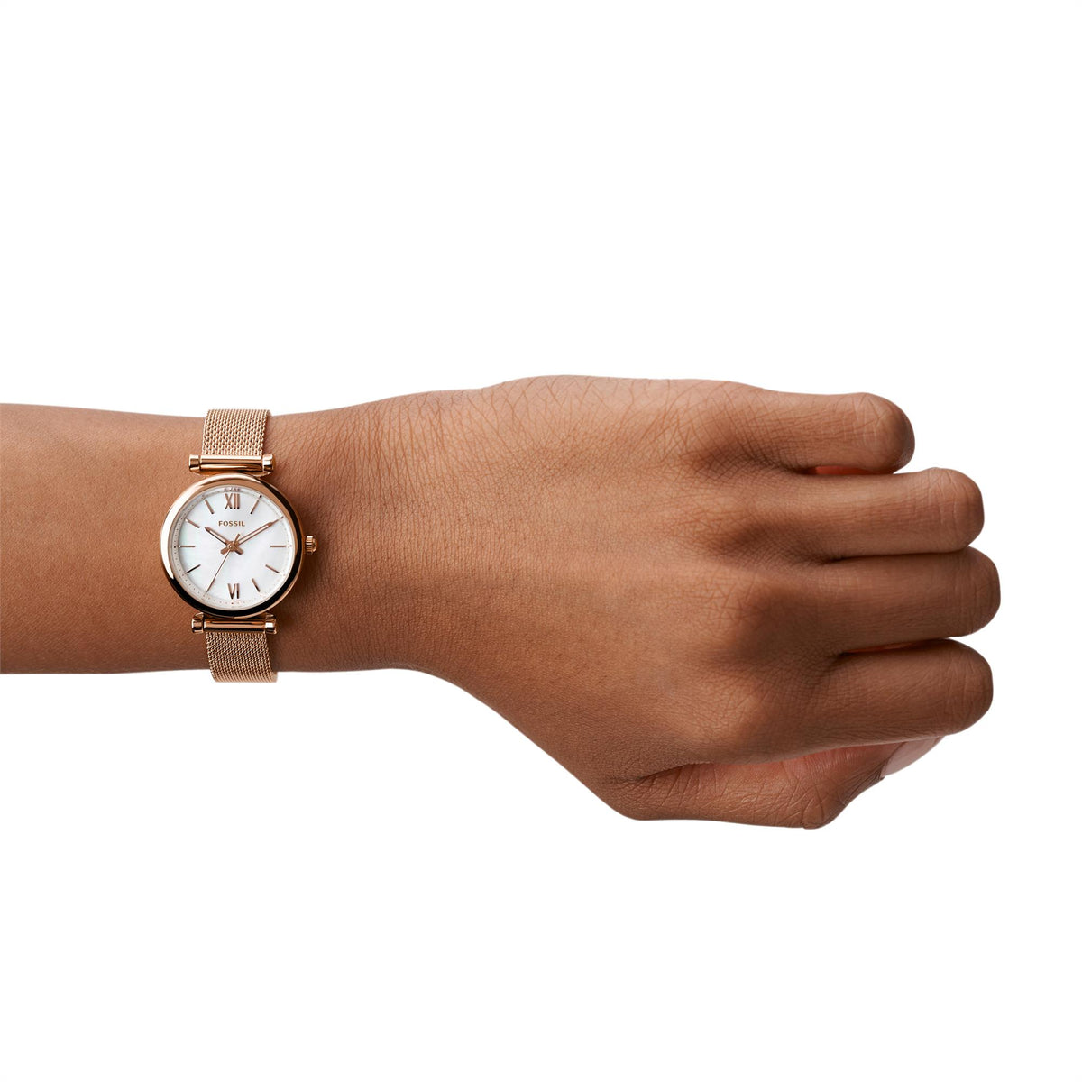 Ladies Fossil quartz watch on wrist with white mother-of-pearl dial and rose gold mesh band