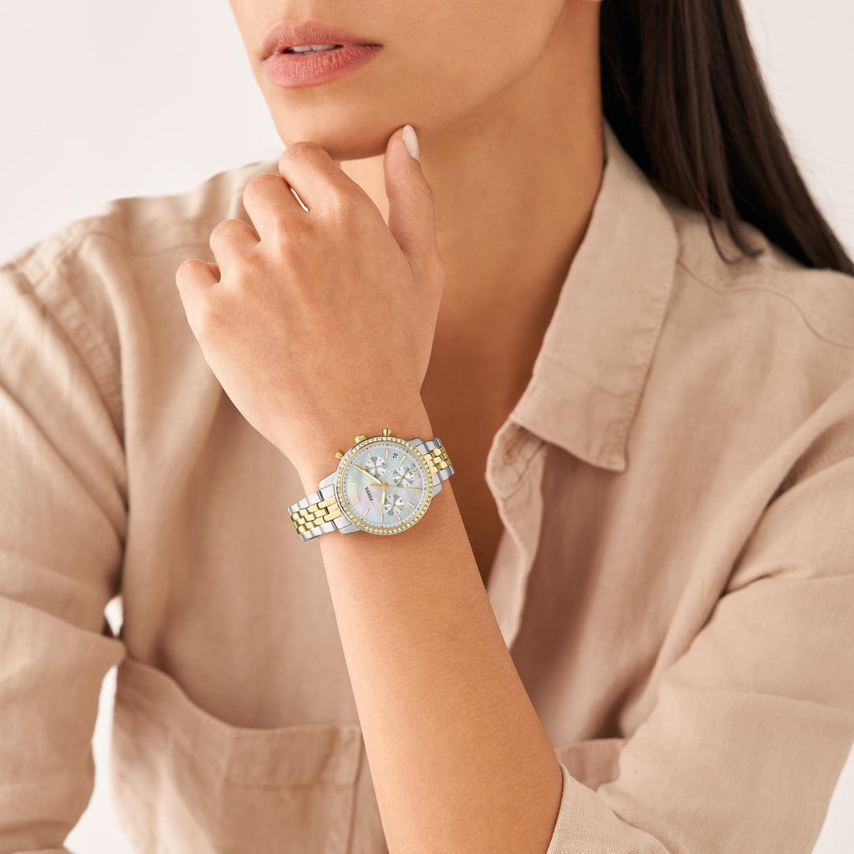 Fossil Neutra chronograph watch on wrist, white dial with gold-tone bracelet links