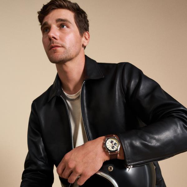 Men's quartz chronograph watch worn on wrist, brown leather strap and cream dial