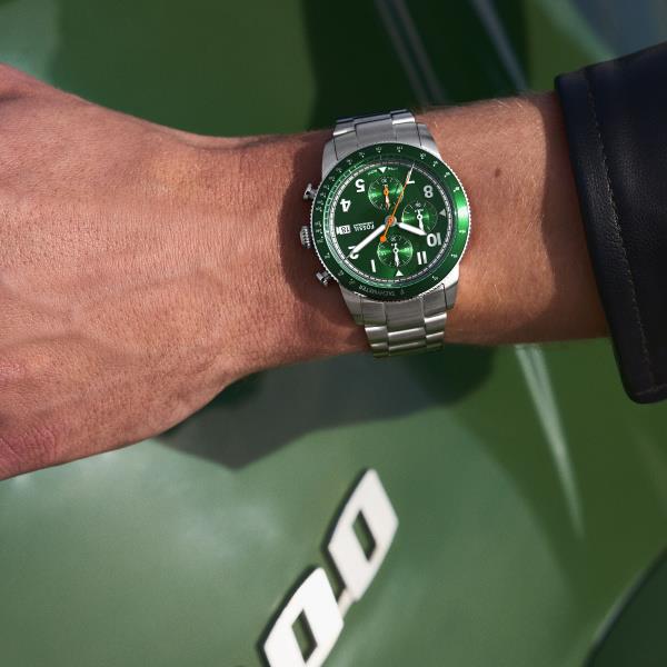 Mens steel quartz chronograph watch with green dial on wrist and metal bracelet