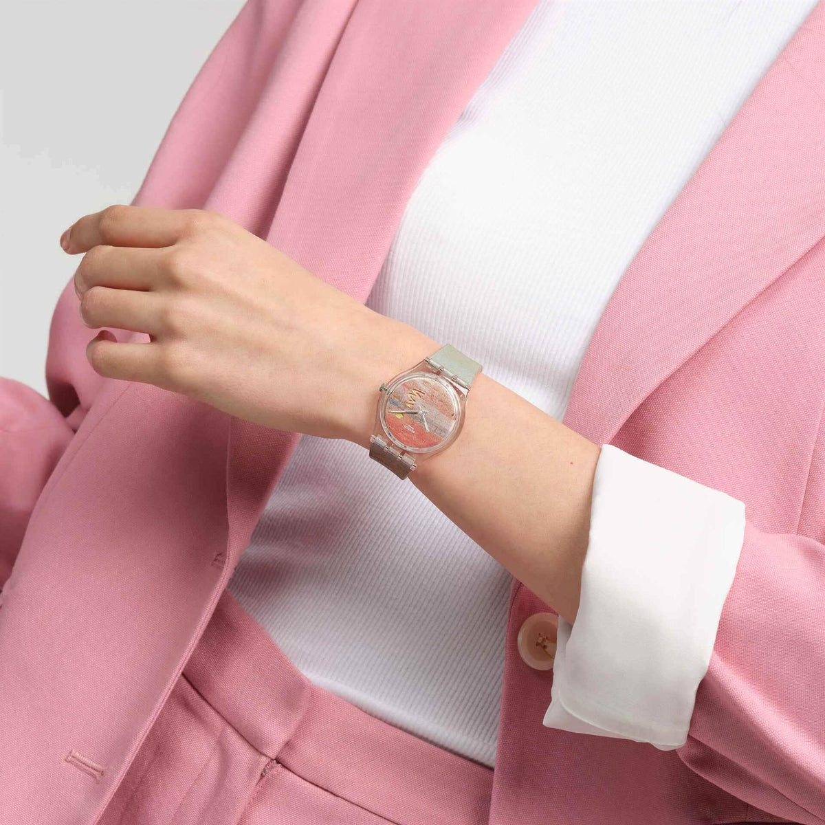 Wrist-worn multicolor silicone strap watch with clear round case and dial