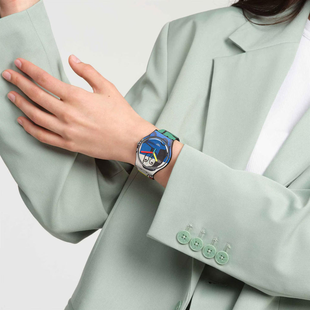 Silicone strap watch on mint blazer sleeve, illustrated blue dial