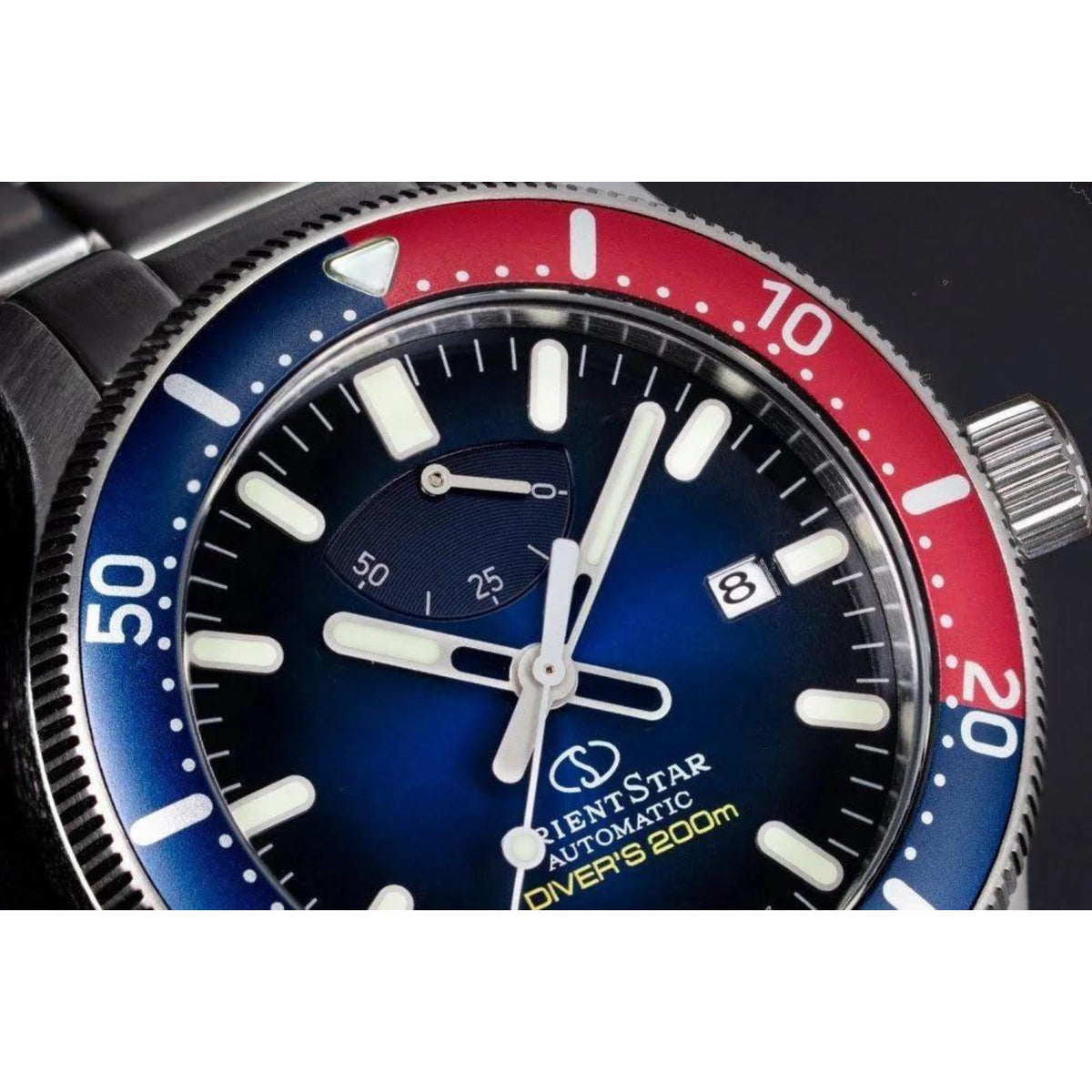 Orient Star diver watch close-up, blue dial, luminous hands and markers, date at 8