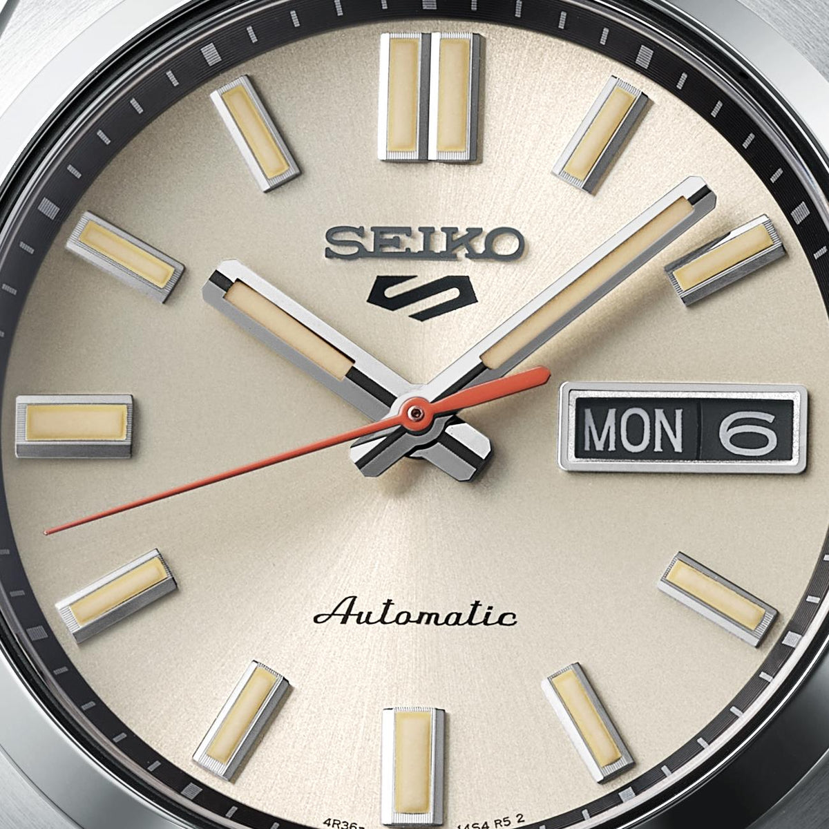 Close-up of Seiko 5 Sports SNXS SRPK91K1 watch face with cream dial 