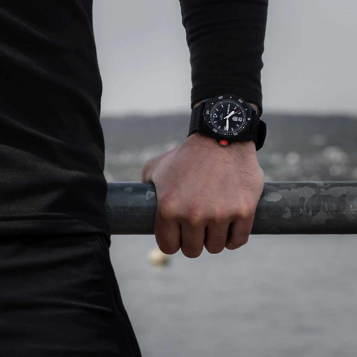 Men's black dial quartz watch with orange accents on black strap