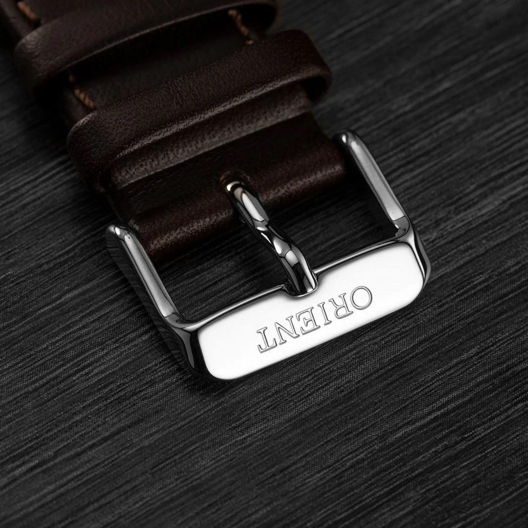 Brown leather watch strap buckle with polished silver clasp, engraved ORIENT