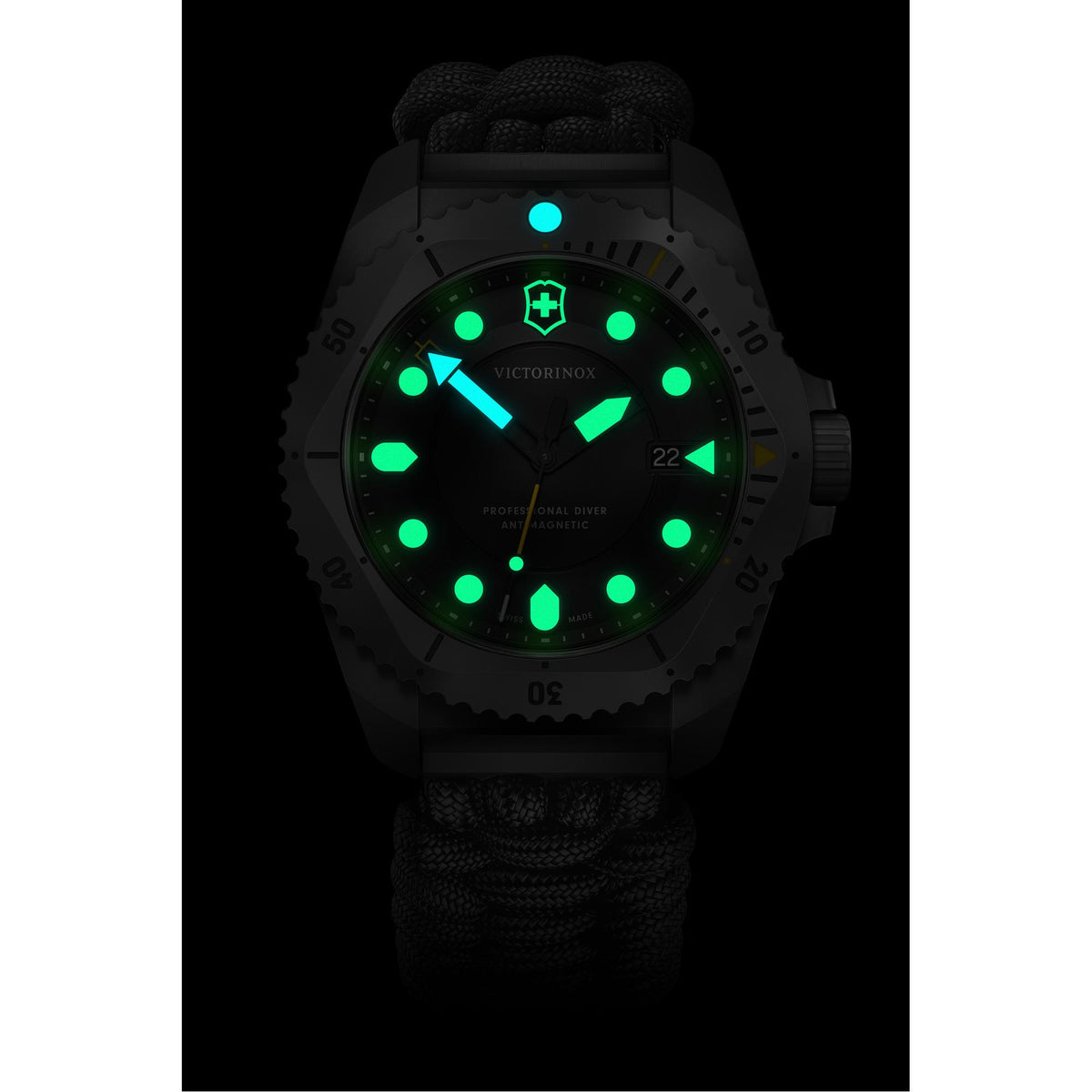 Victorinox Dive Pro watch, featuring green and blue glowing lume and a black paracord strap