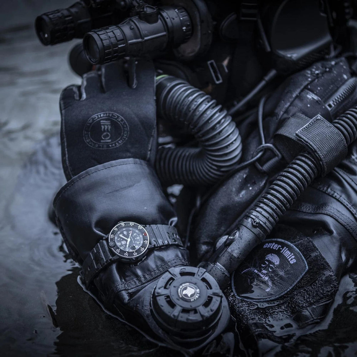 Men's black rubber quartz diver watch with black dial and luminous hands on black glove