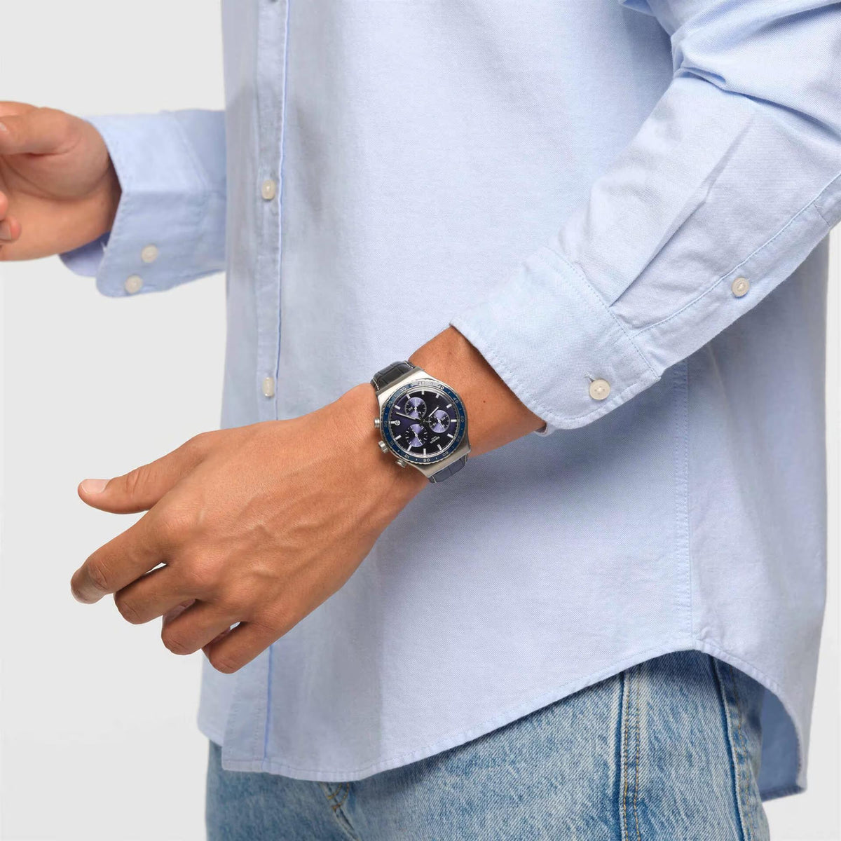 Chronograph watch with blue dial and black leather strap on wrist