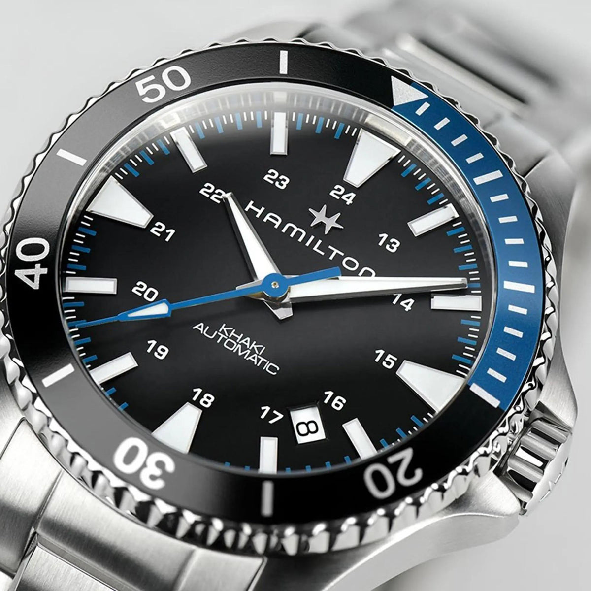 Hamilton Khaki Navy H82315131 black dial with luminous indices and blue seconds hand close-up