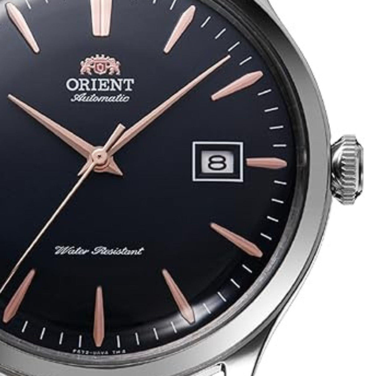 Men's Orient Bambino automatic watch face close-up, dark blue dial and date window