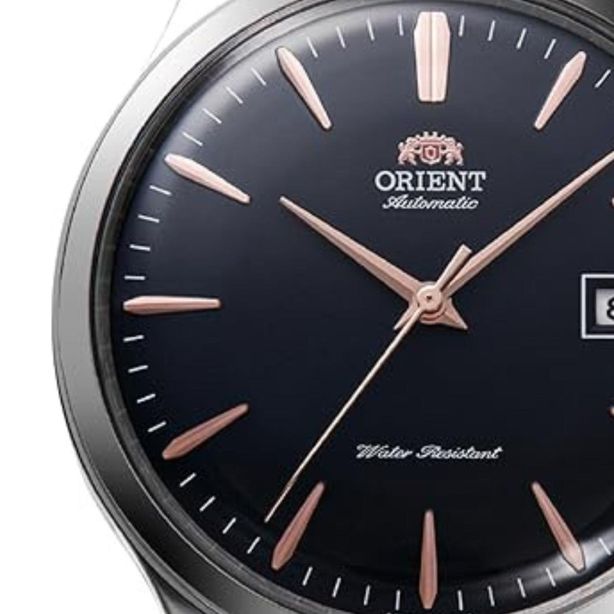 Men's Orient Bambino automatic watch close-up, dark blue dial and rose-gold hour markers