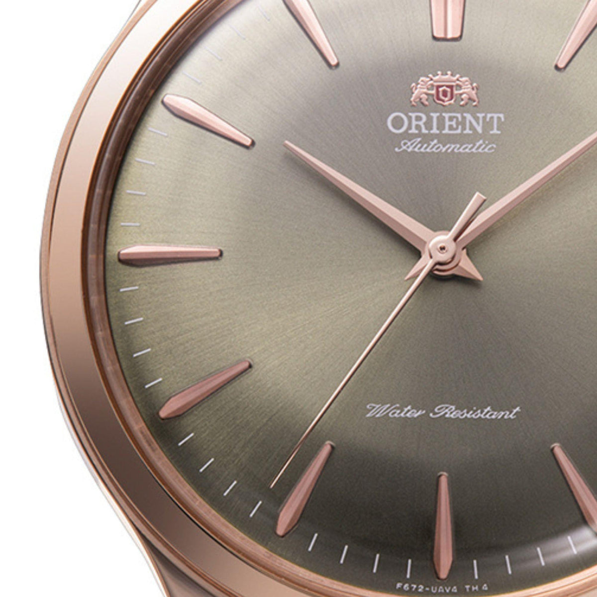 Men's bronze-tone automatic watch dial close-up, rose indices and Orient Automatic logo