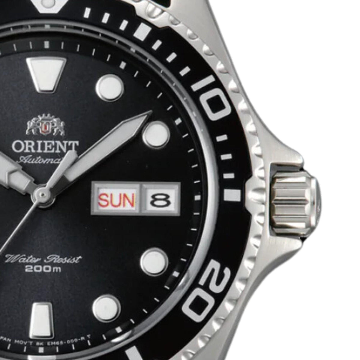 Close-up of black dial with date window reading SUN and 8, silver bezel markings