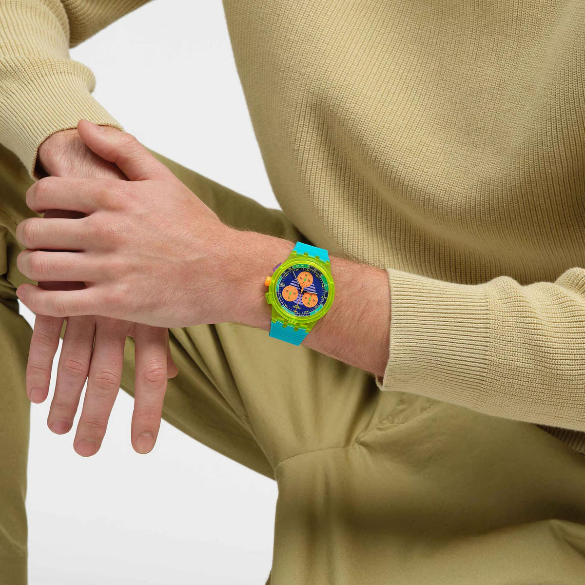 Turquoise silicone chronograph watch on wrist with bright multicolor dial