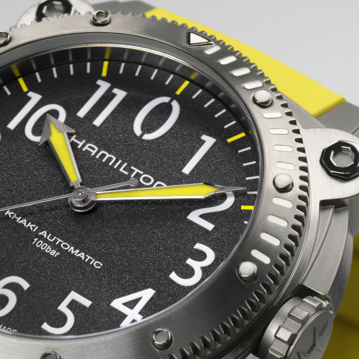 Close-up of a Hamilton Khaki Automatic watch dial with a yellow hands