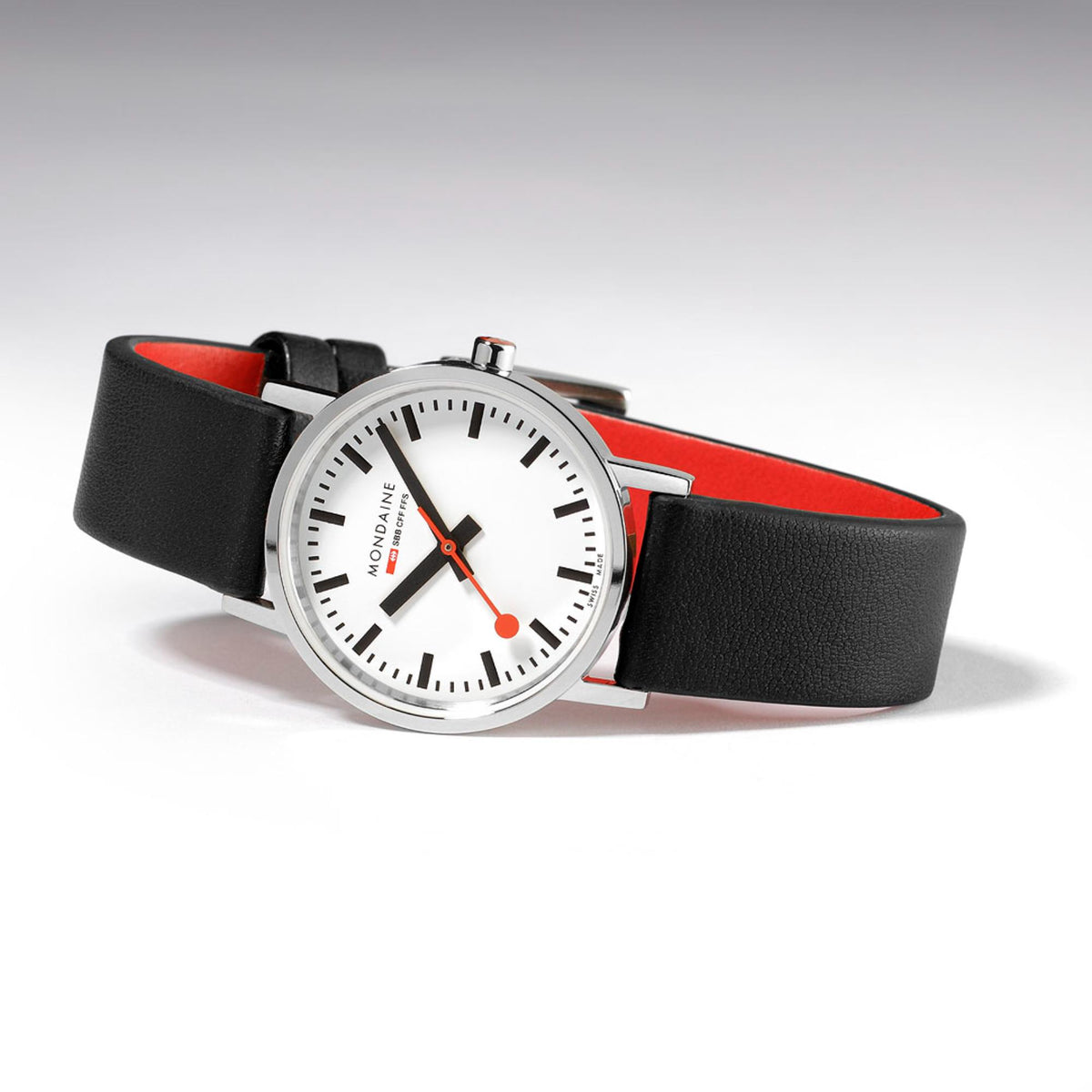 Mondaine Classic A658.30323.11SBBV dress watch positioned horizontally, showing a white dial and a red second hand