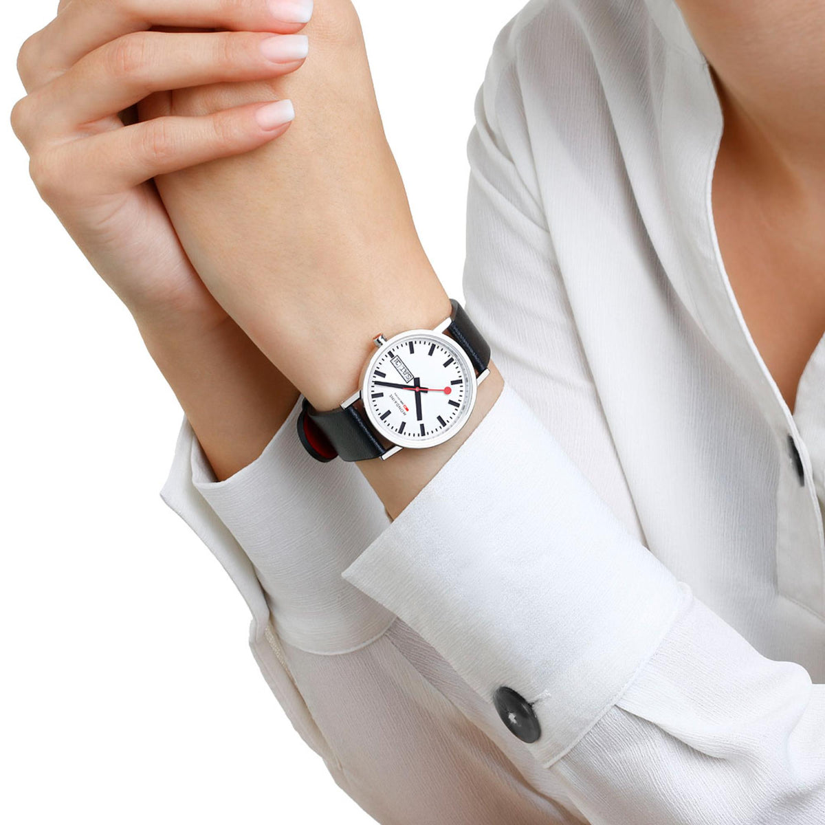 Mondaine Classic A667.30314.11SBBV on wrist paired with a white button-down shirt, emphasizing its minimalist style