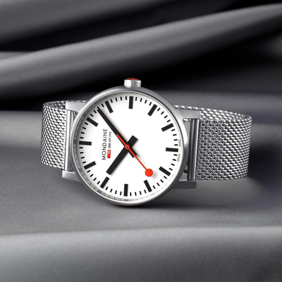 Mondaine Evo2 MSE.43110.SJ analog wristwatch angled view resting on a grey textured fabric surface