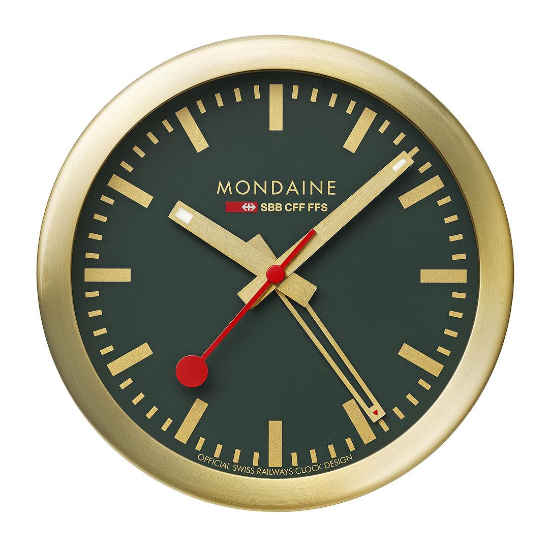 Gold-tone table clock with forest green dial, red hands, and gold hour markers.