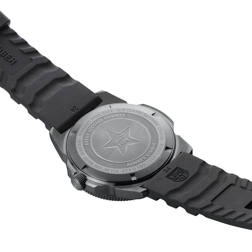 Diver watch caseback close-up with engraved back and black rubber band
