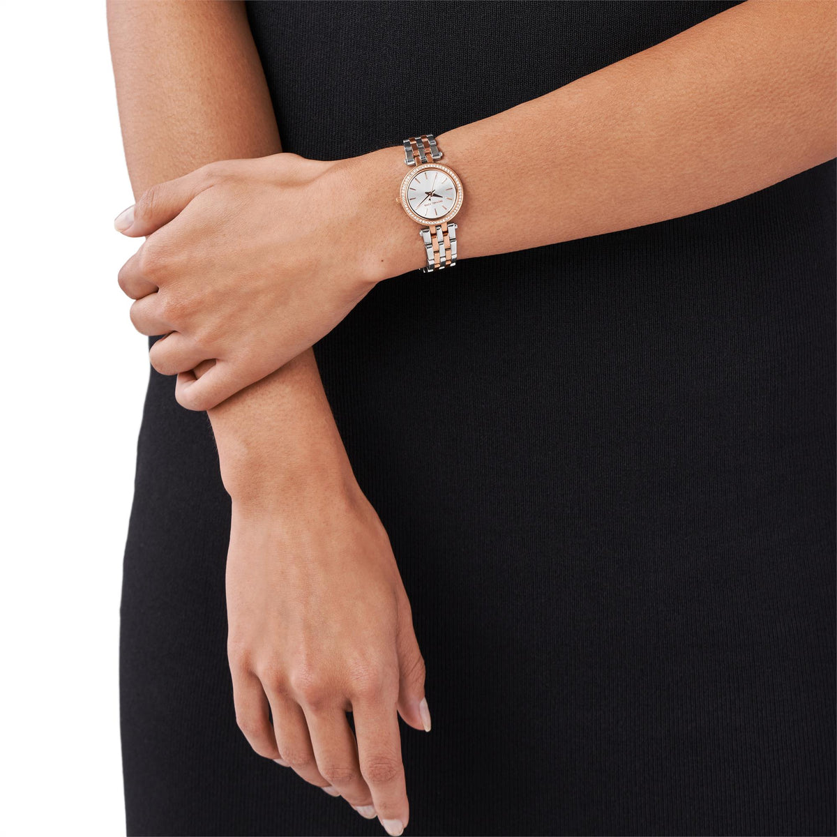 Two-tone stainless steel watch on wrist with silver dial and rhinestone bezel