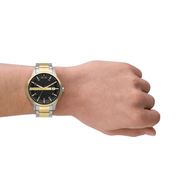 Armani Exchange Hampton quartz watch on wrist, black dial with gold bezel and steel band