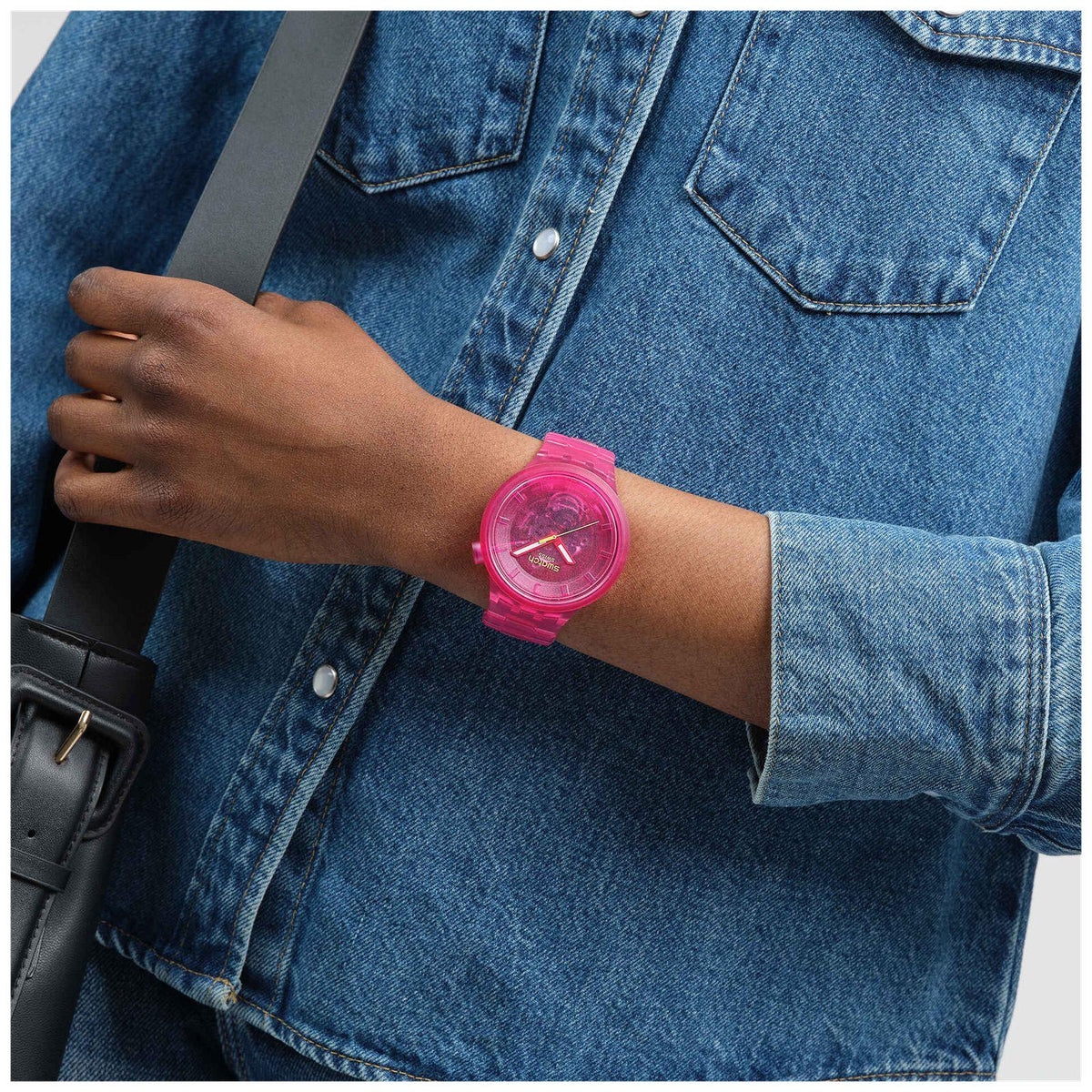 Pink Joy bio-sourced watch on wrist with pink dial and pink translucent strap