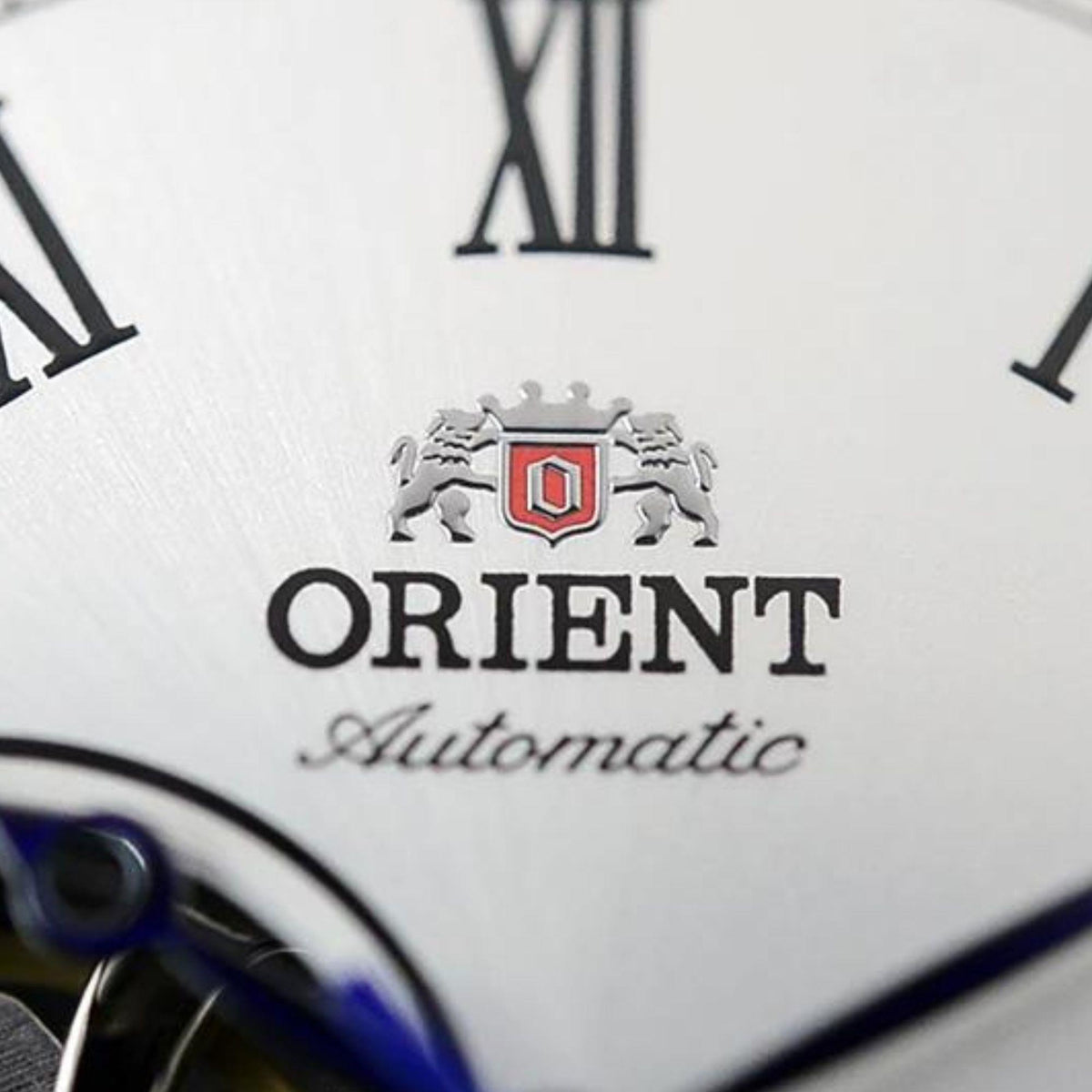 Orient Automatic logo and crest on white watch dial with Roman numeral markers