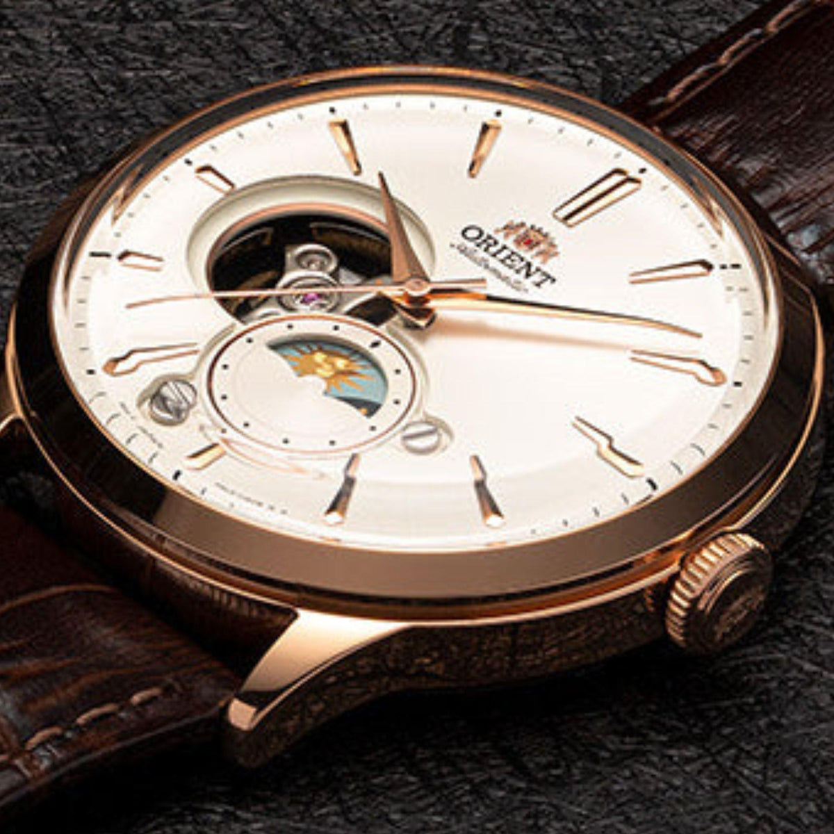 Men's automatic watch top view: white dial with exposed gears, sun-moon aperture, leather strap