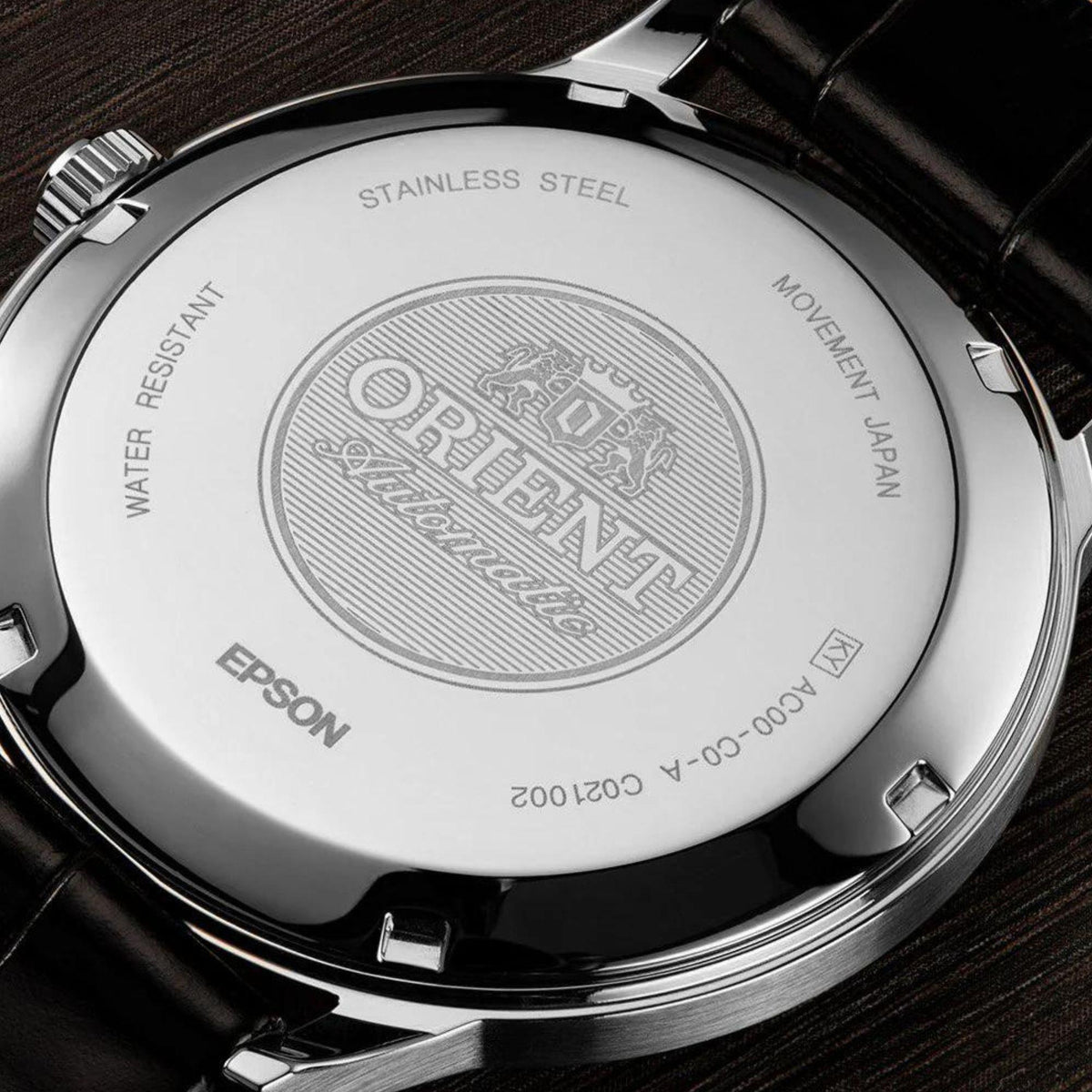Stainless steel case back of Orient Bambino automatic watch on black leather strap