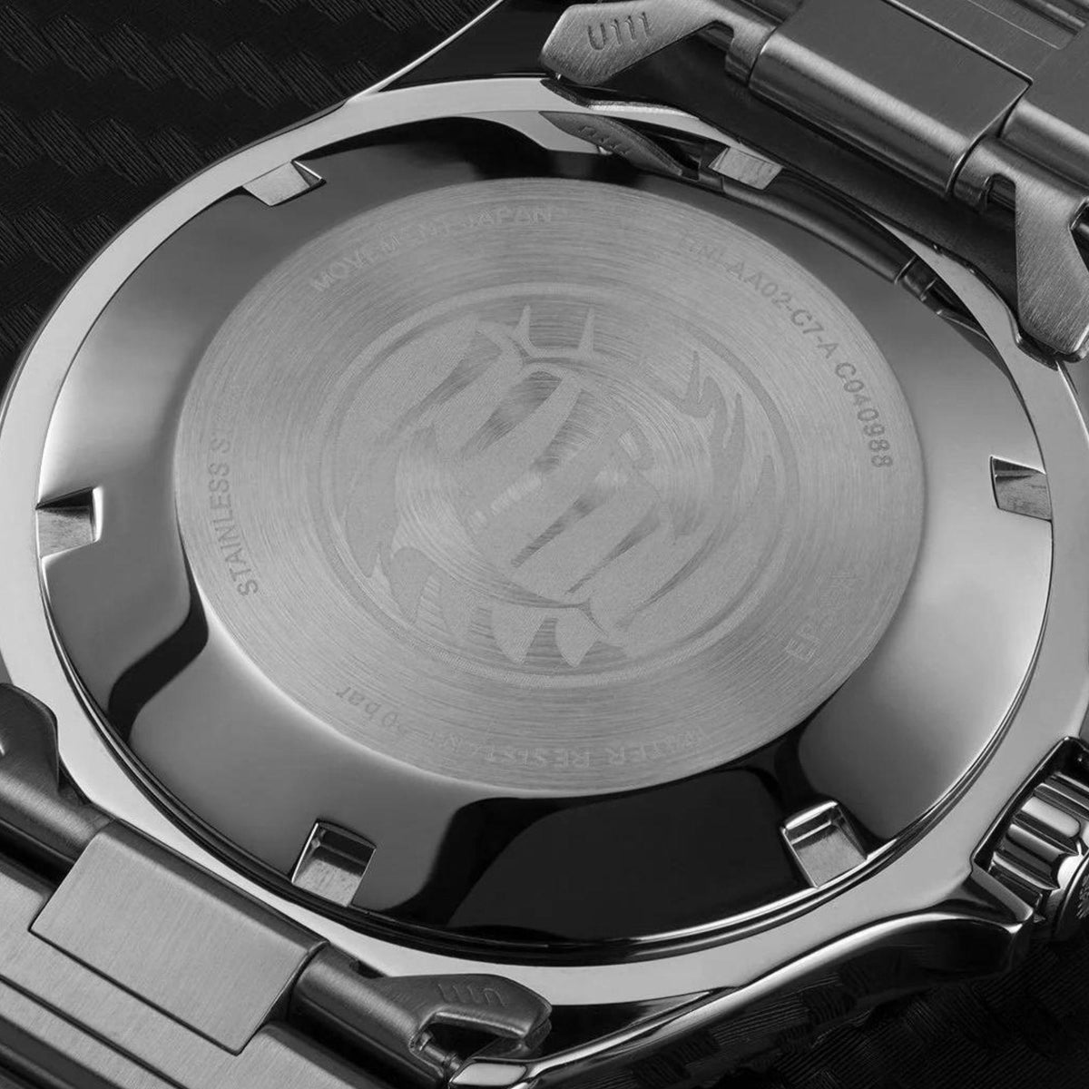 Stainless steel caseback with engraved emblem and water-resistance text